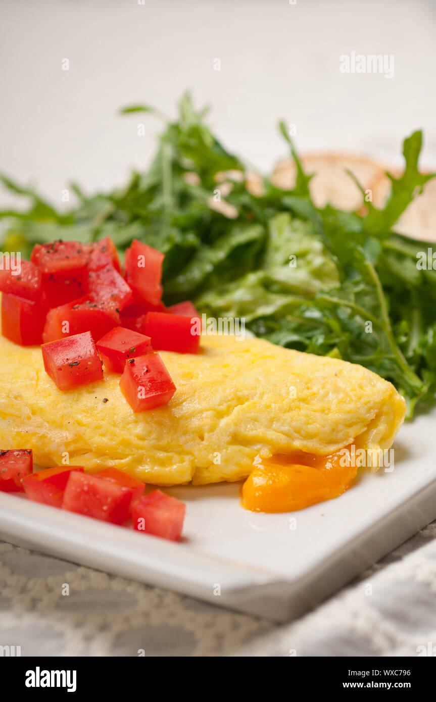 home made omelette with cheese tomato and rucola rocket salad arugola Stock Photo
