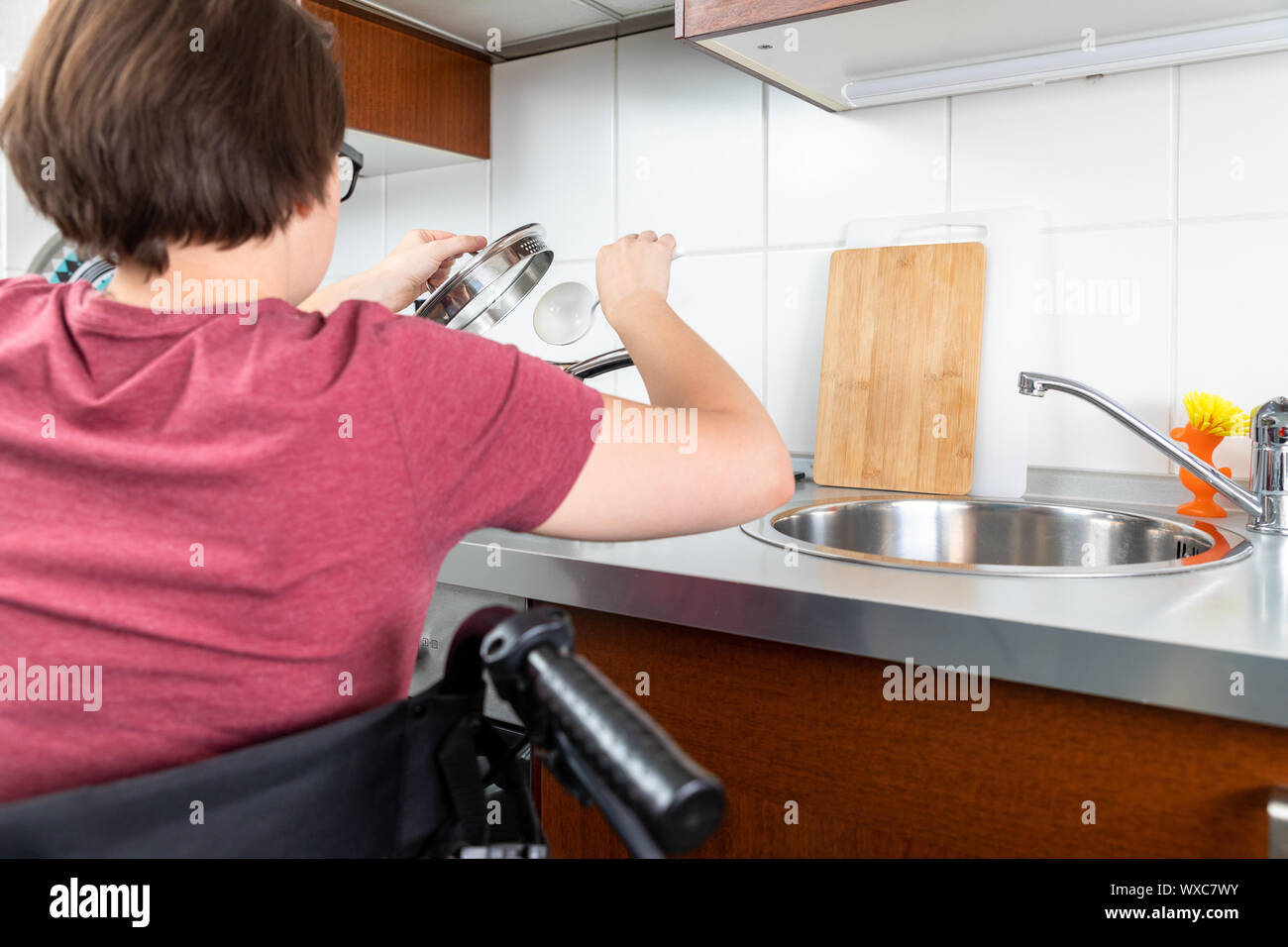 disabled woman cooking in the kitchen Stock Photo Alamy