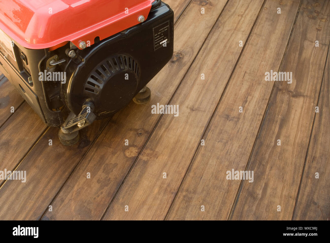 Home power backup electricity generator on wooden table - space for text Stock Photo