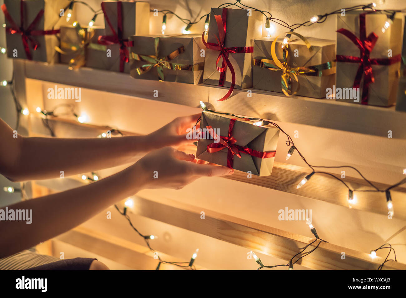 Mom makes an advent calendar for a child a son or daughter on the