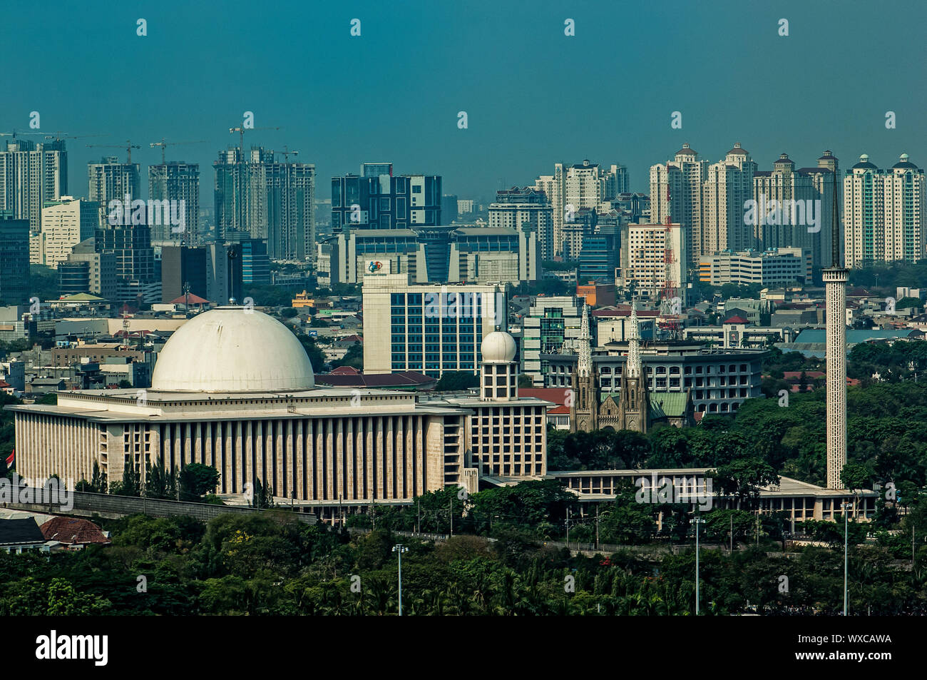 Istiqlal Mosque, between Jakarta's buildings Stock Photo