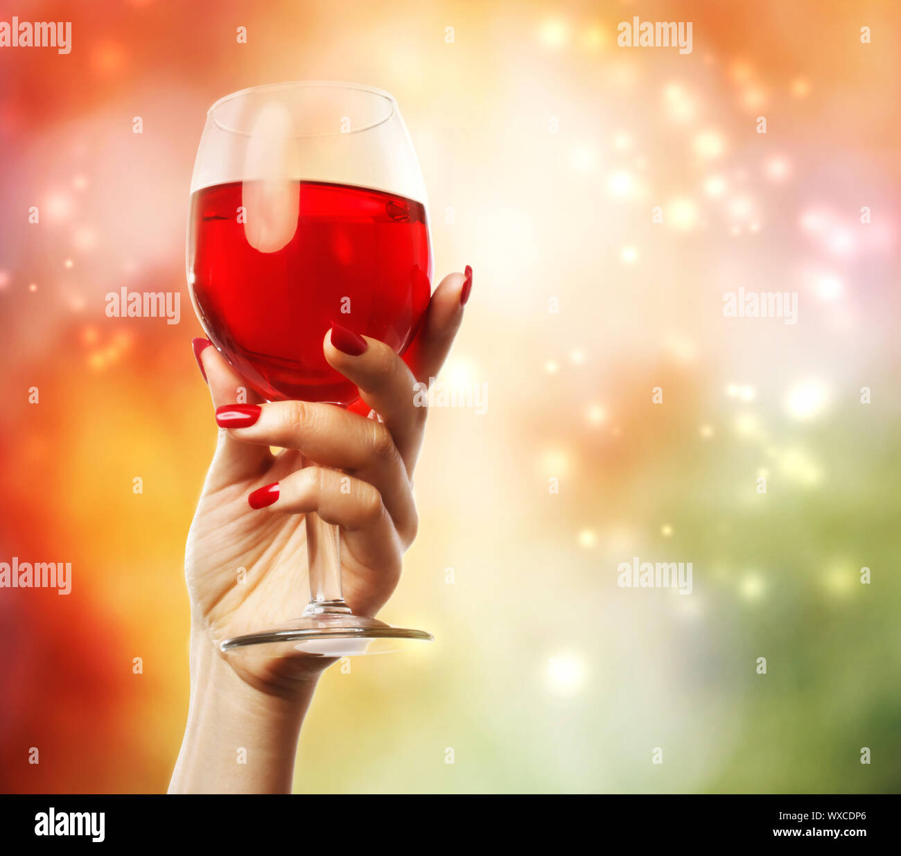 Woman holding a wine glass on abstract light background Stock Photo - Alamy