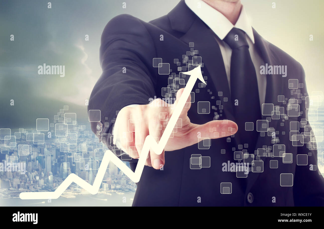 Businessman Touching a Graph Indicating Growth Stock Photo