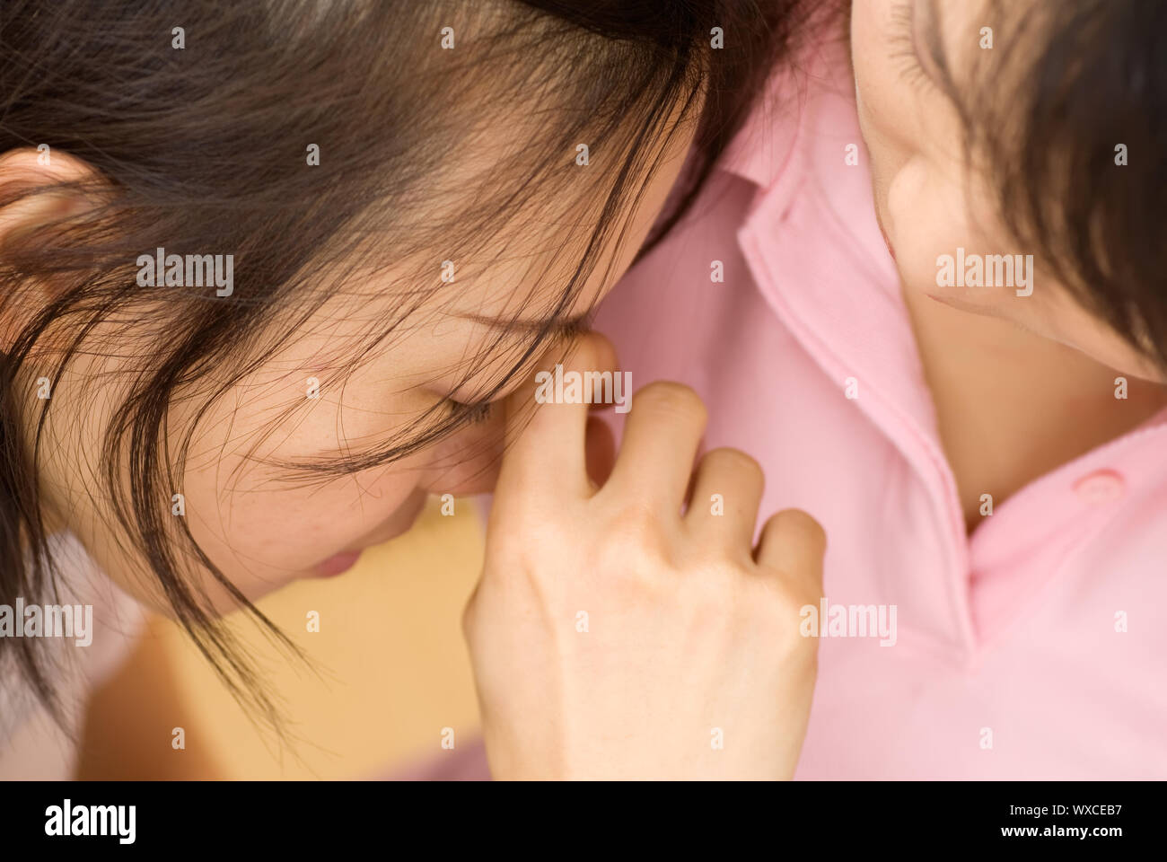 Sad woman leaning on shoulders of friend and wipe eyes Stock Photo - Alamy