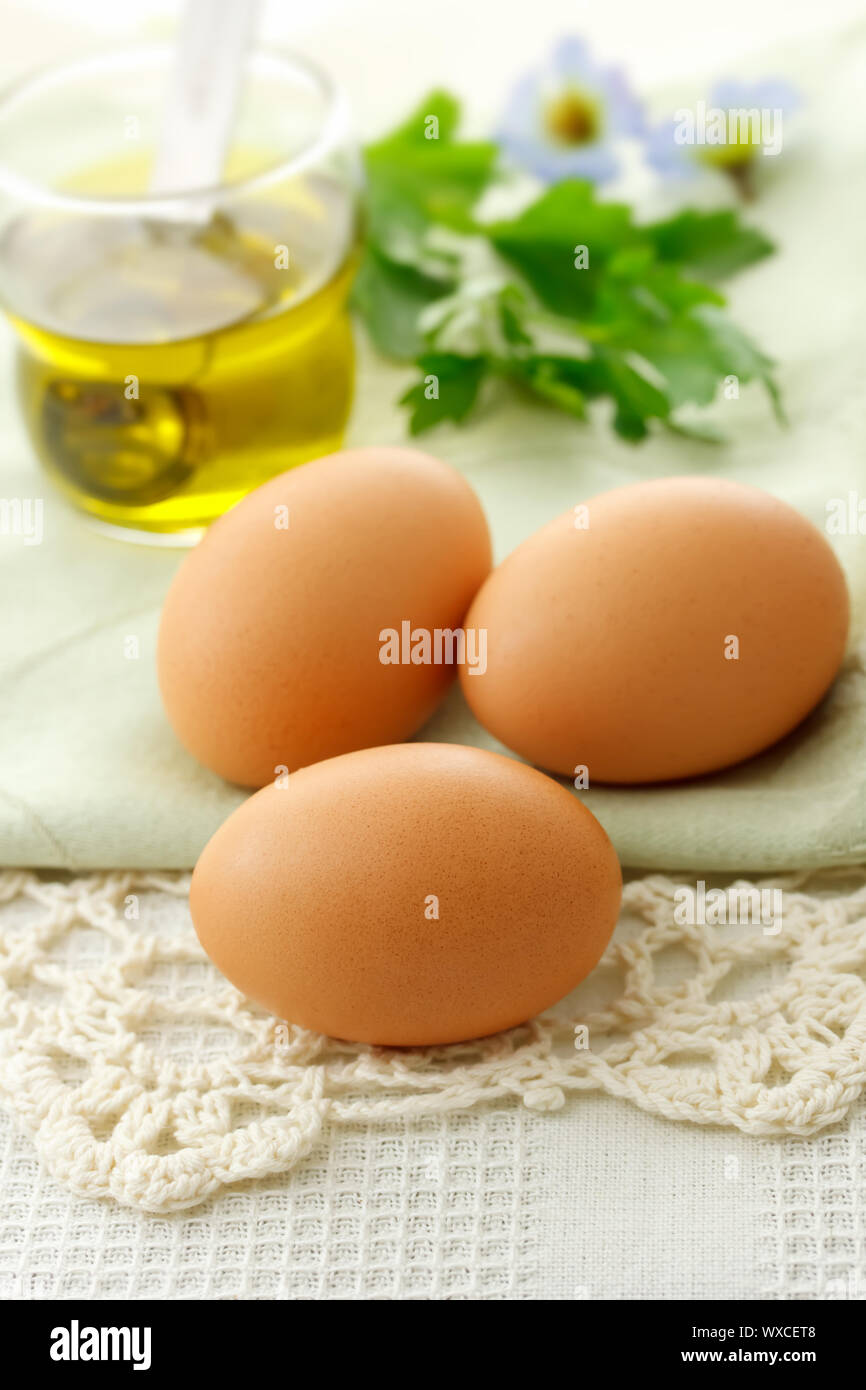 Fresh eggs with olive oil on the table Stock Photo