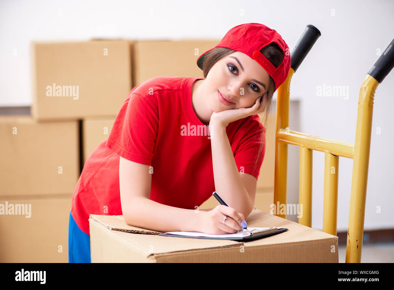 Young female professional mover doing home relocation Stock Photo