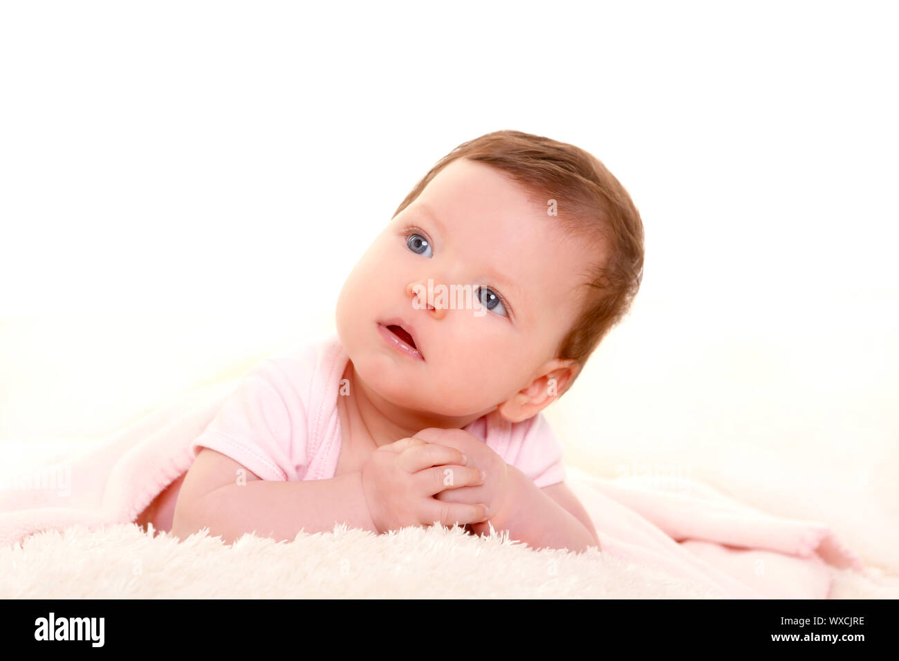 baby girl smiling dress in pink with winter white fur background Stock ...