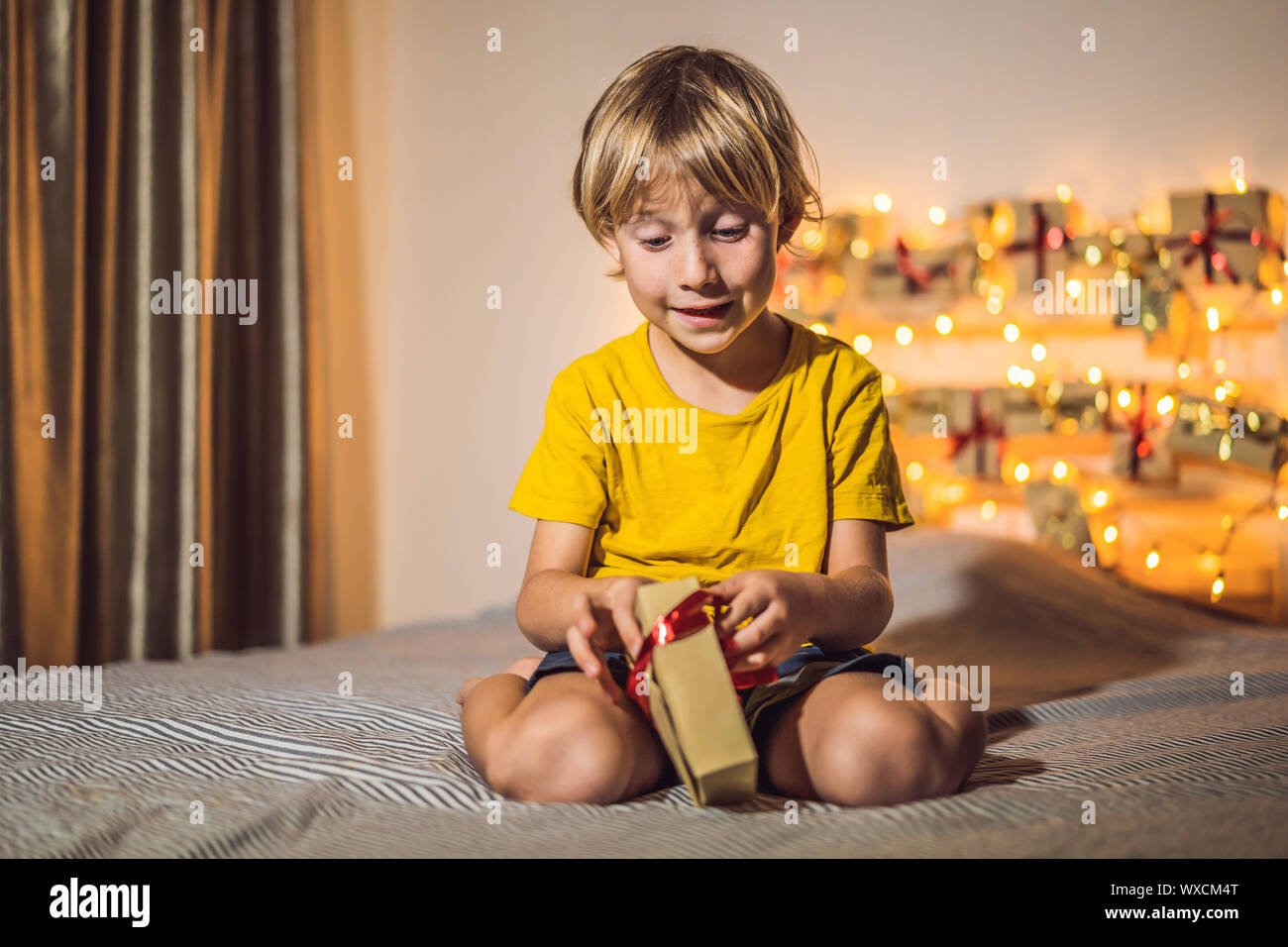The boy opens a gift from the advent calendar Stock Photo