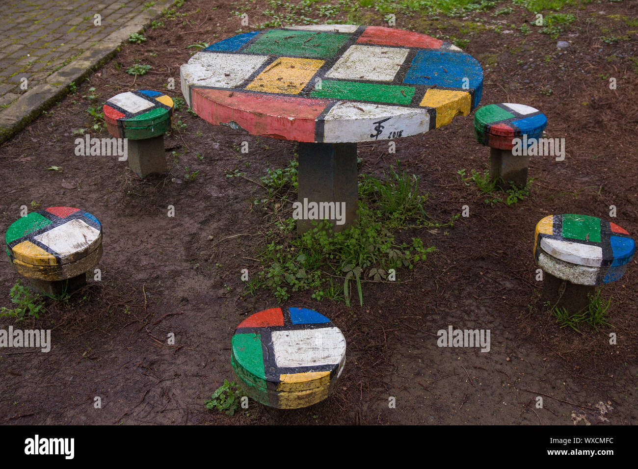 colorful concrete table with chairs Stock Photo - Alamy