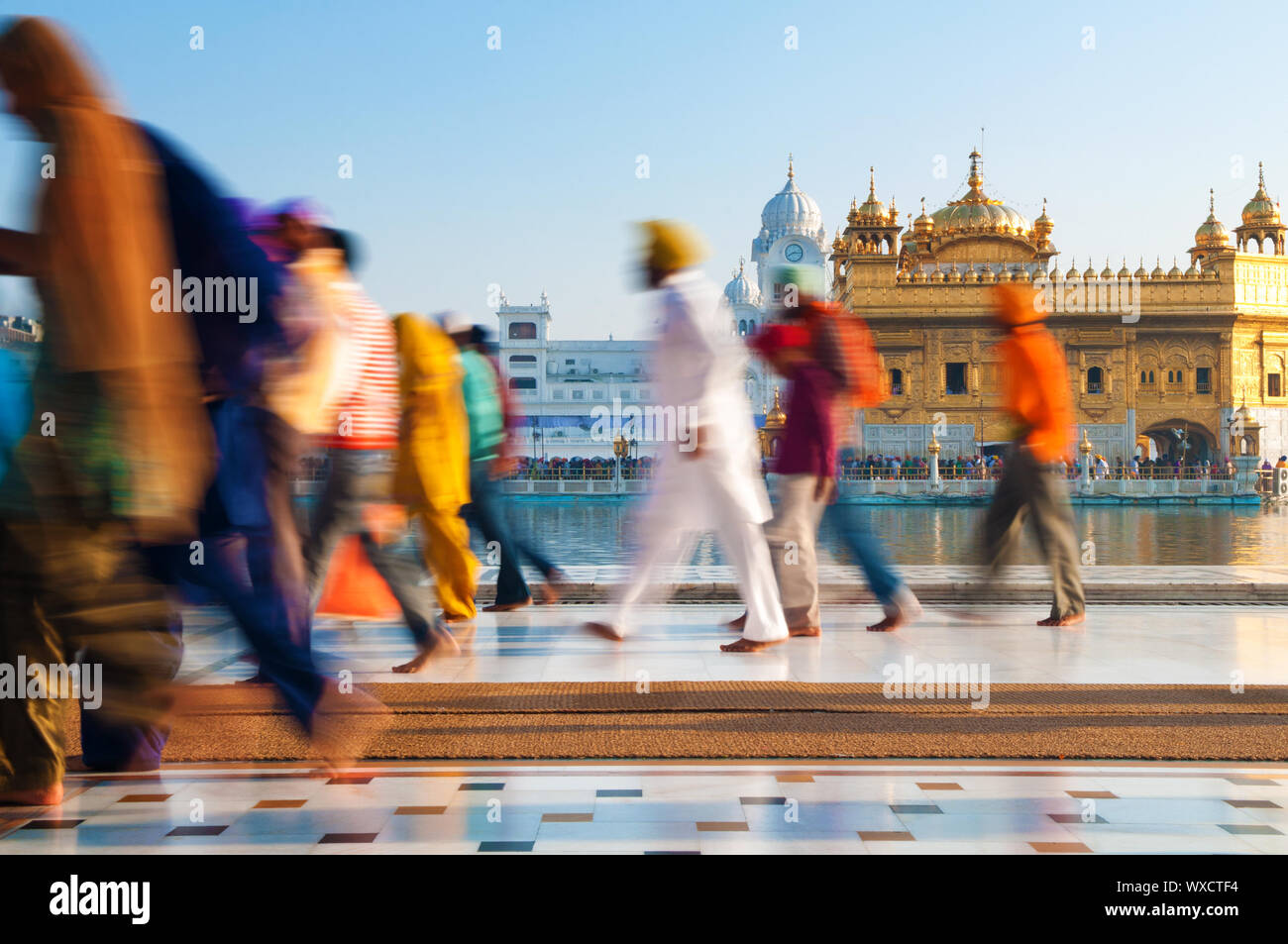 Group of Sikh pilgrims walking by the holy pool, Golden Temple ...