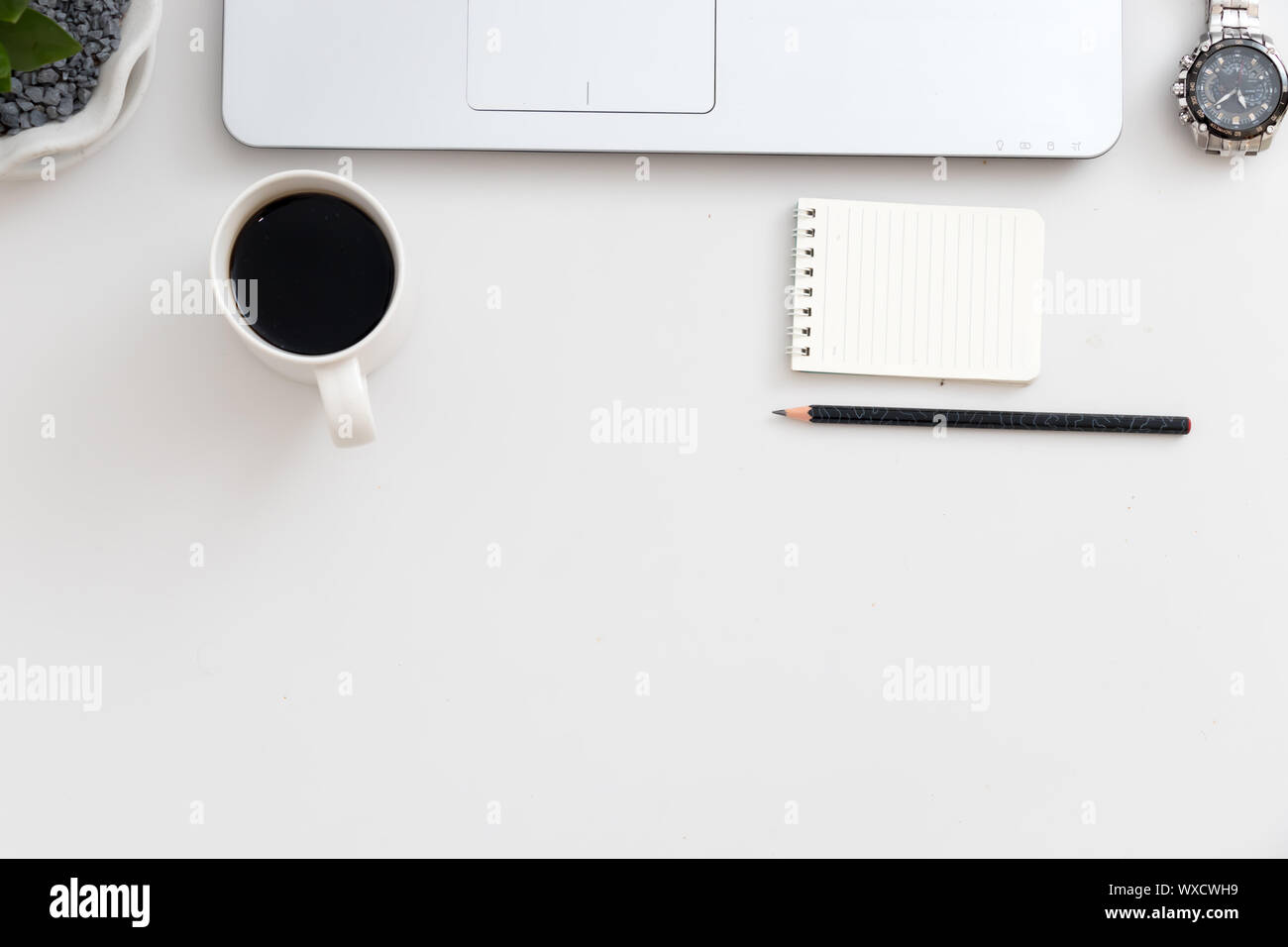 White office desk with laptop watch, notebook with pen Stock Photo - Alamy