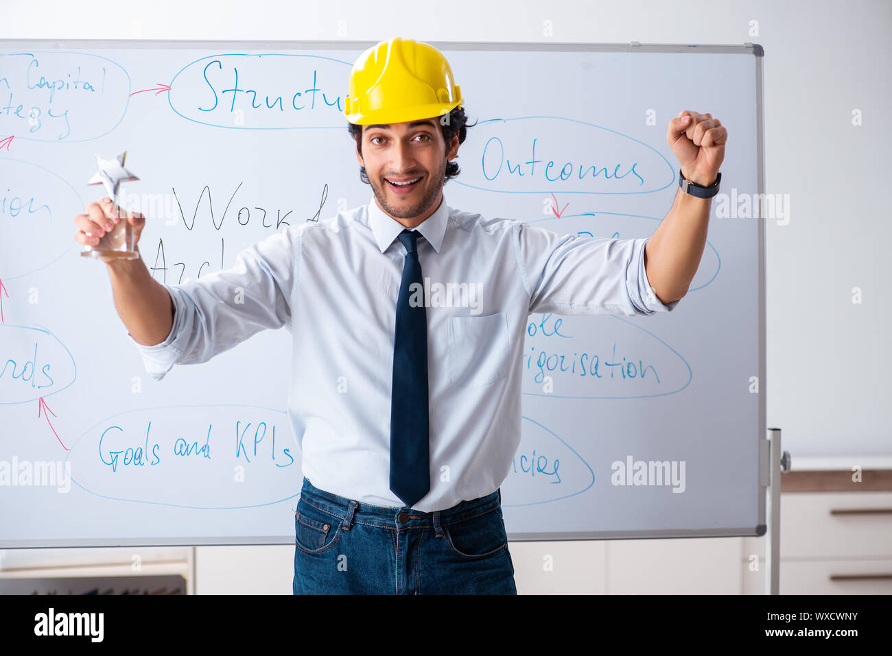 Young male architect in front of the whiteboard Stock Photo