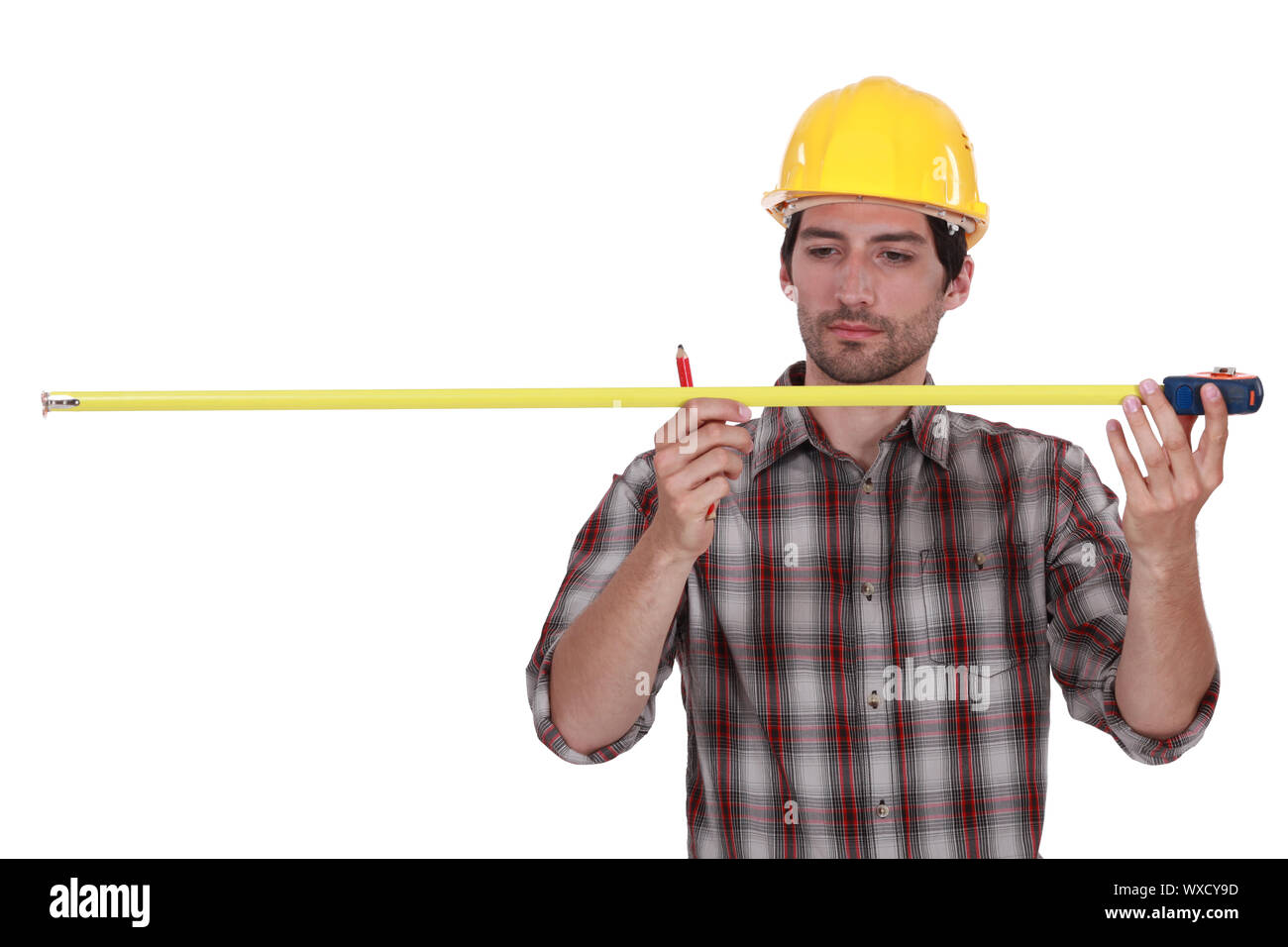 Tradesman using a measuring tape Stock Photo