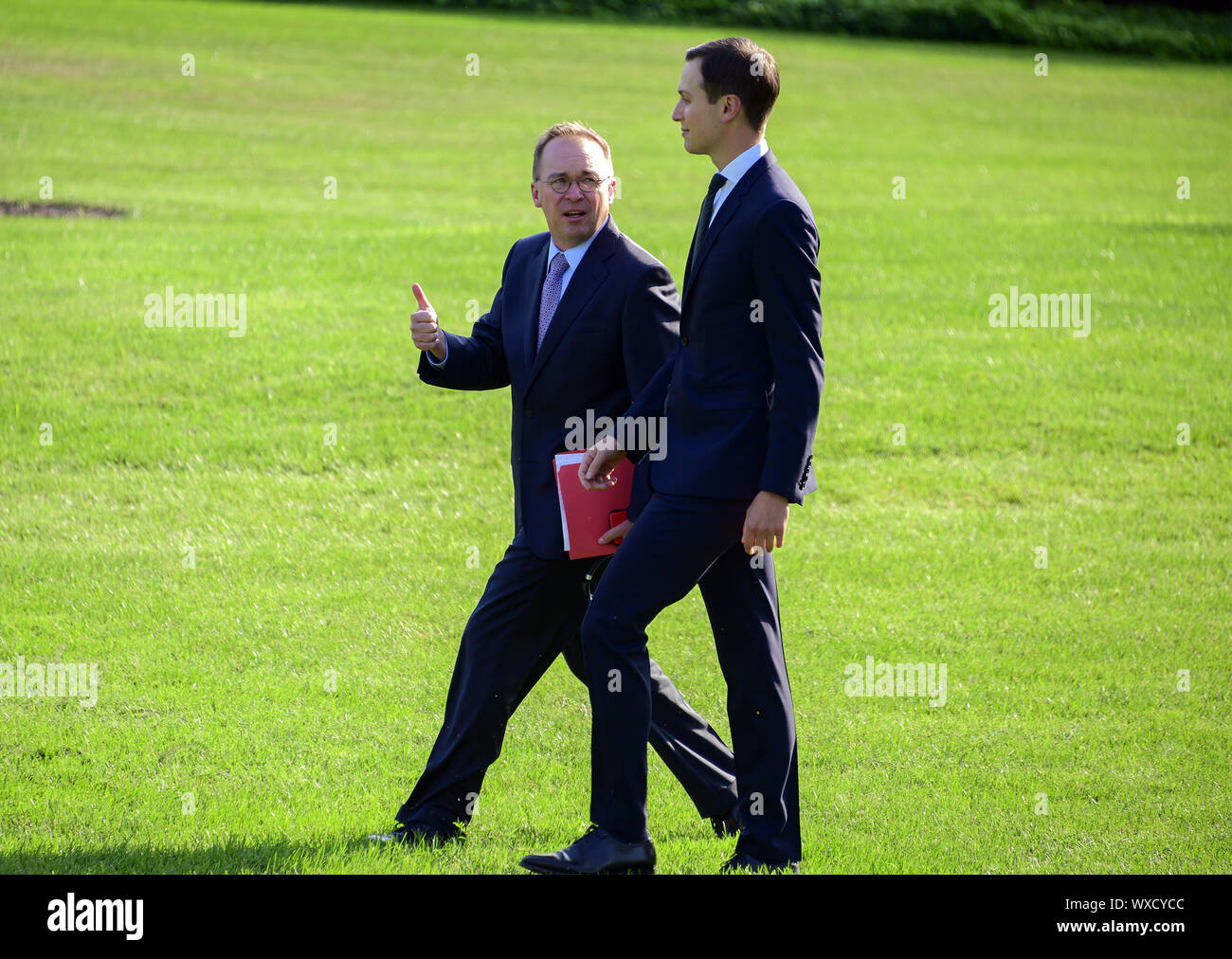 Washington, District of Columbia, USA. 16th Sep, 2019. Acting White House Chief of Staff and Director of the Office of Management and Budget (OMB) Mick Mulvaney, left, converses with Senior Advisor Jared Kushner, right, as they walk across the South Lawn of the White Hopuse in Washington, DC to join United States President Donald J. Trump aboard Marine One as he prepares to depart for a trip to the western US on Monday, September 16, 2019. He will return early Thursday morning Credit: Ron Sachs/CNP/ZUMA Wire/Alamy Live News Stock Photo