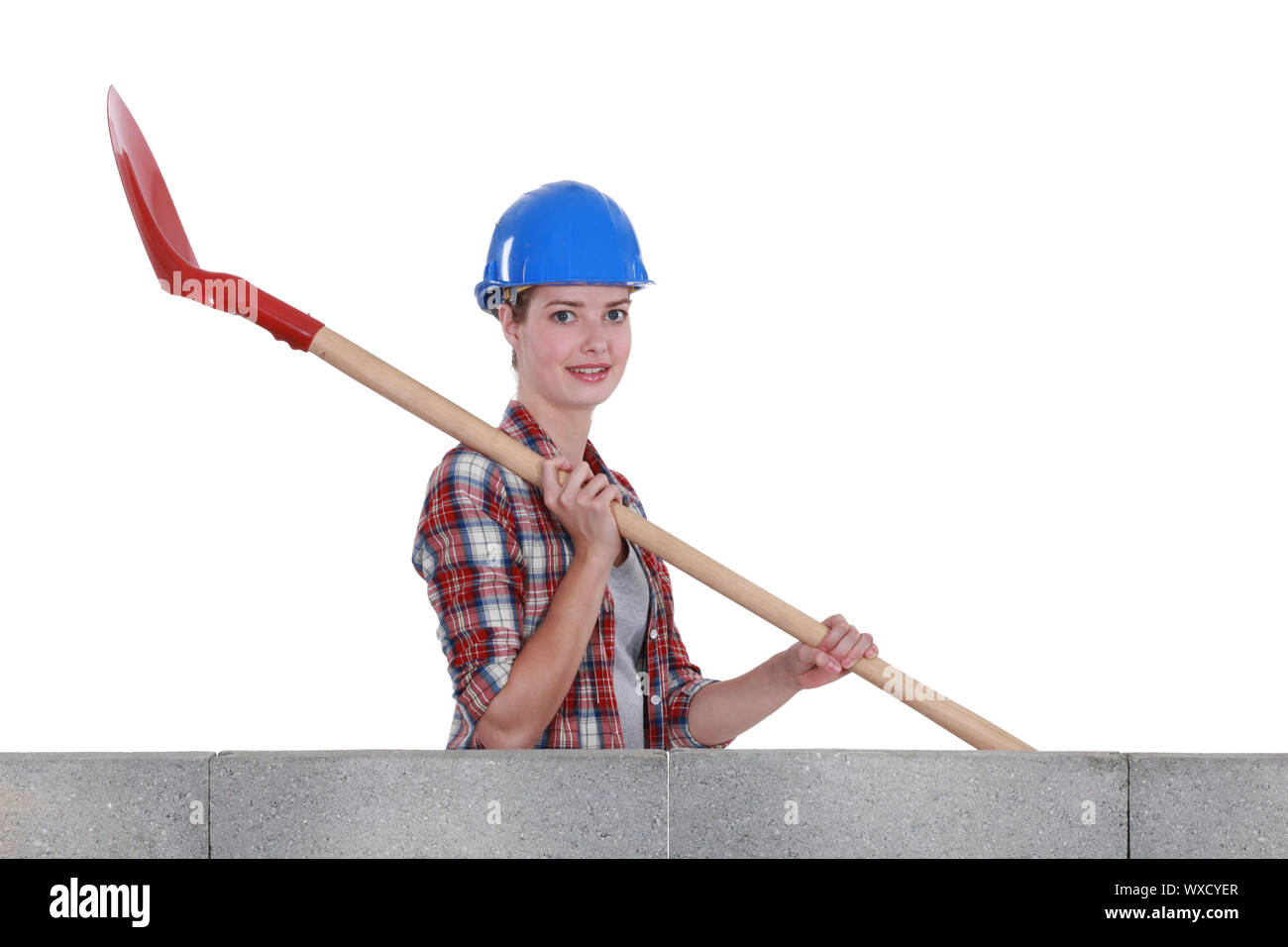 Female mason holding shovel Stock Photo