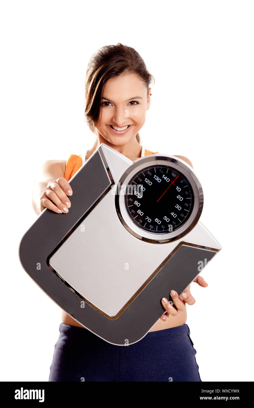 Portrait of a beautiful athletic girl holding a scale, isolated on ...
