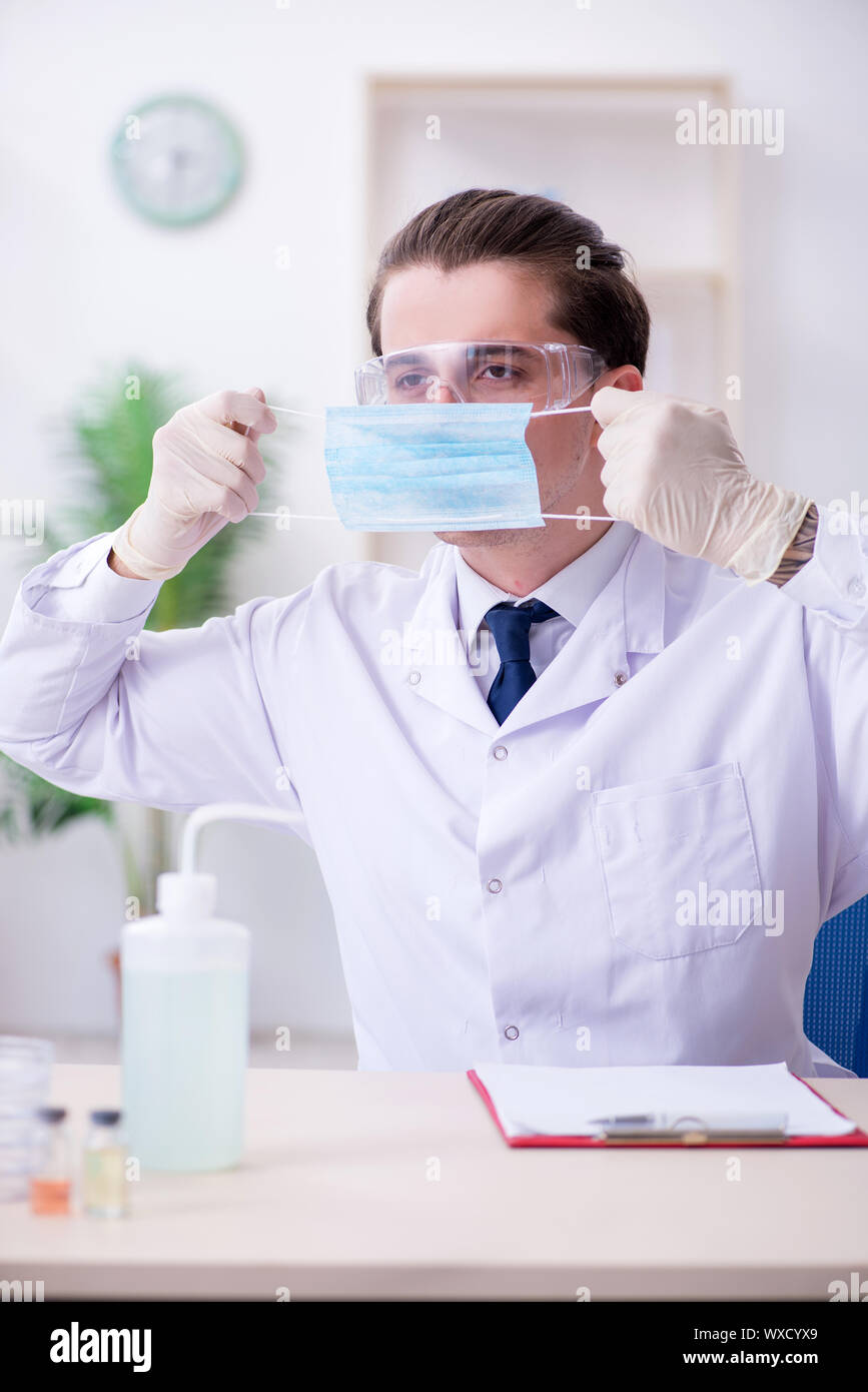 Young male chemist experimenting in lab Stock Photo