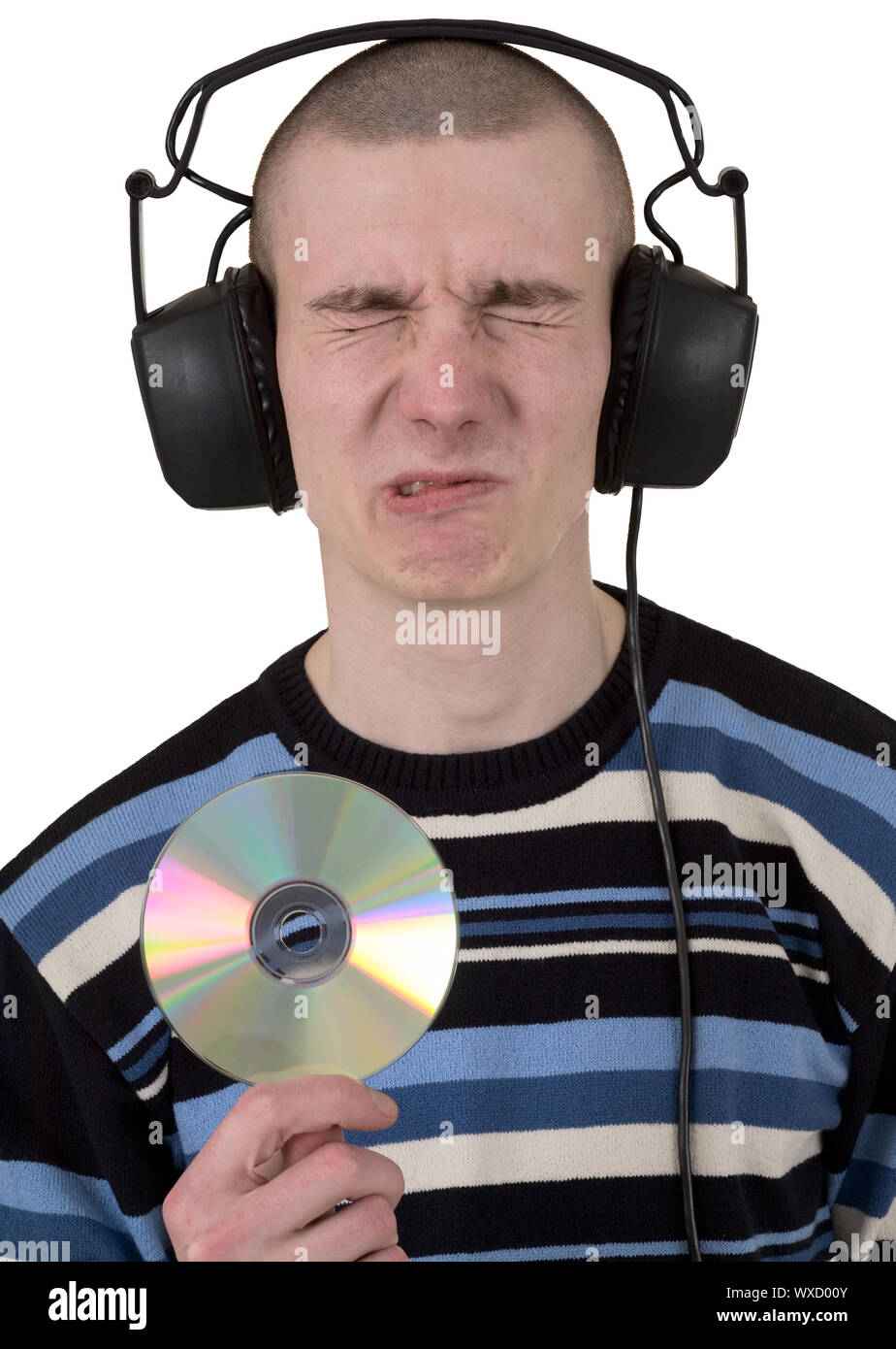 The young guy with ear-phones on a head and compact disk in hand Stock Photo