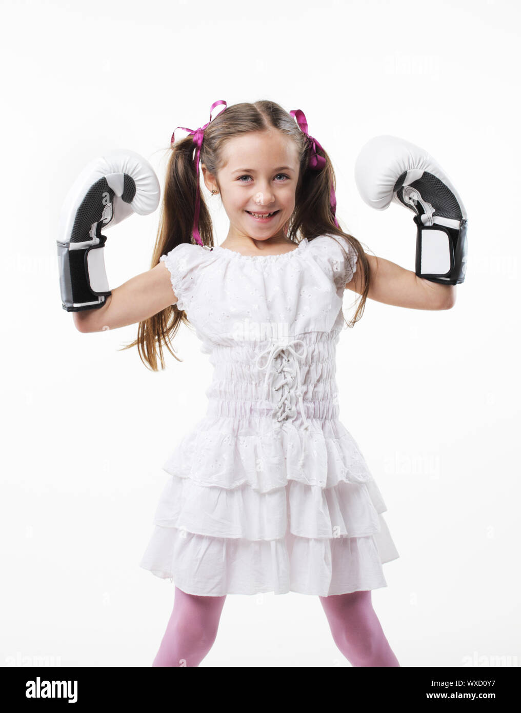 Smiling little girl wearing boxing gloves Stock Photo Alamy