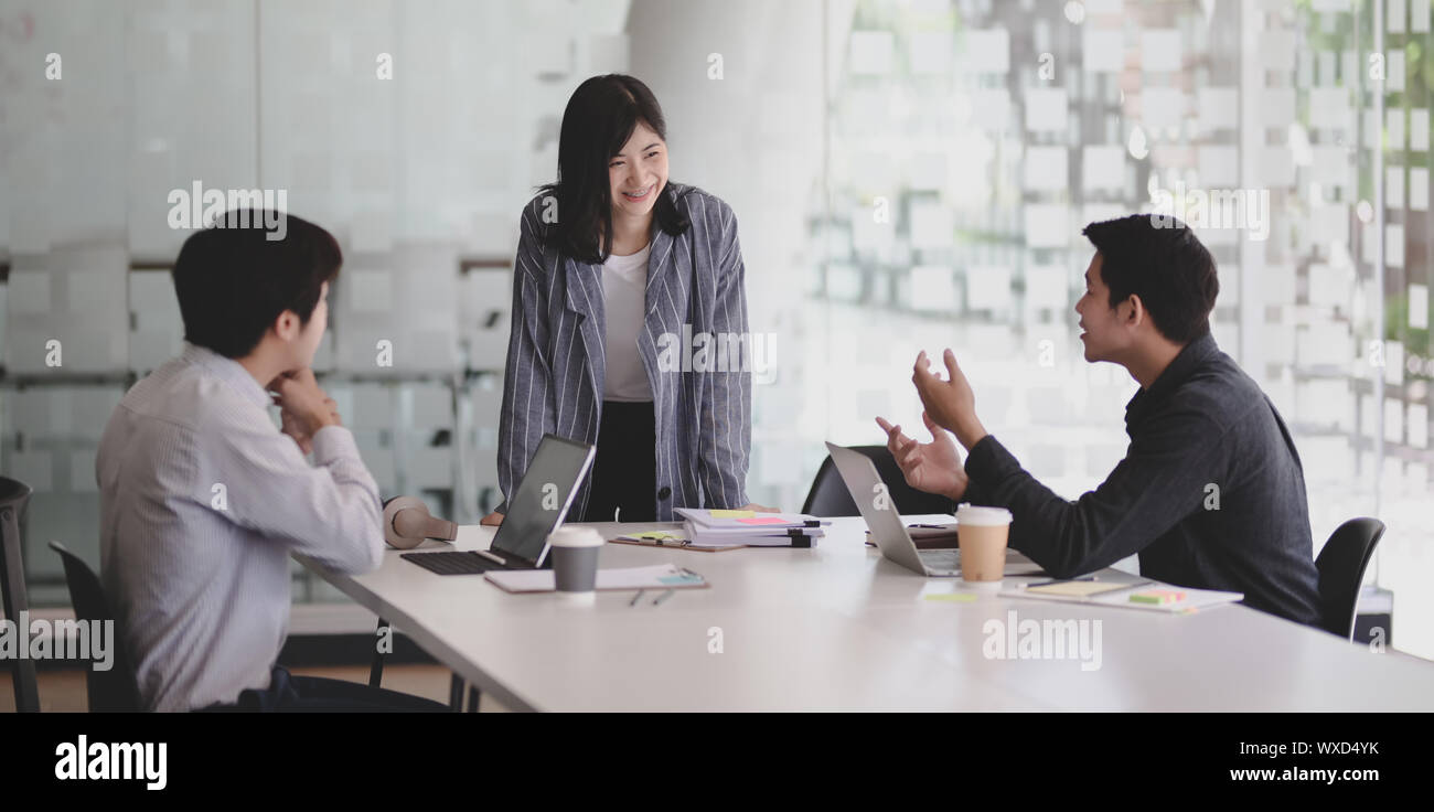 Group of young professional business people discussing their project ...