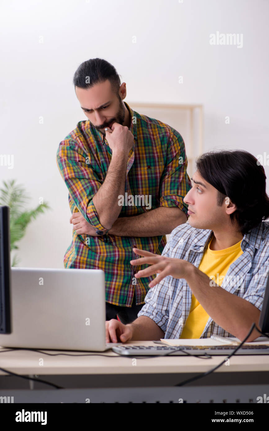 Two it specialists working in the office Stock Photo