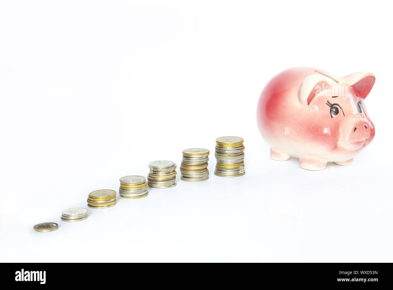 Pink piggy bank isolated on white background with coins Stock Photo - Alamy