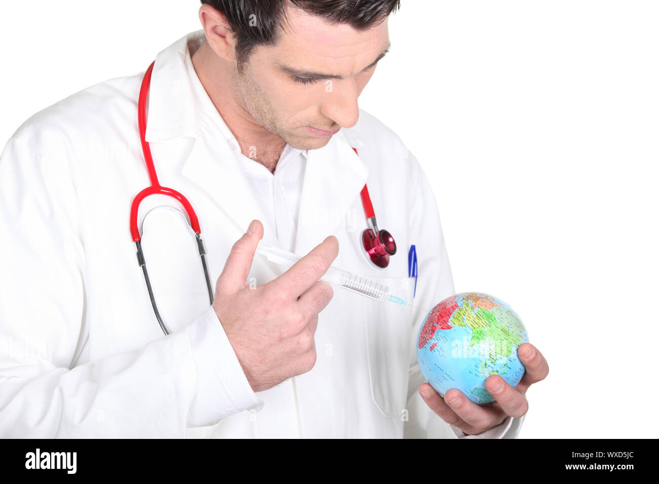 Medical professional giving a shot to a mini-globe Stock Photo
