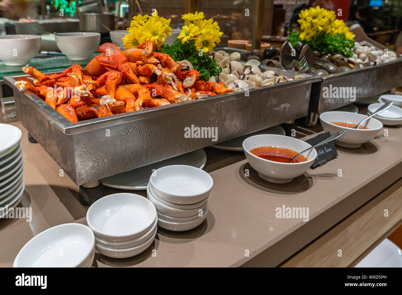 Crab claw and clam at seafood counter in buffet restaurant Stock Photo