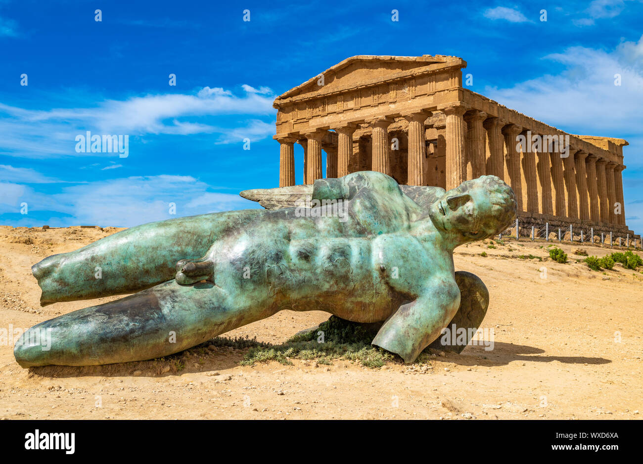 Temple of Concordia and the statue of Fallen Icarus, in the Valley of the Temples, Agrigento, Sicily, Italy Stock Photo