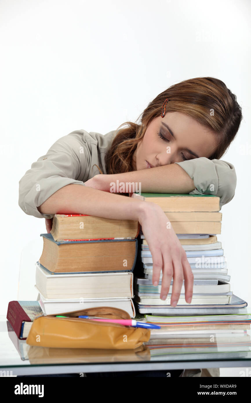student sleeping over a pile of books Stock Photo - Alamy