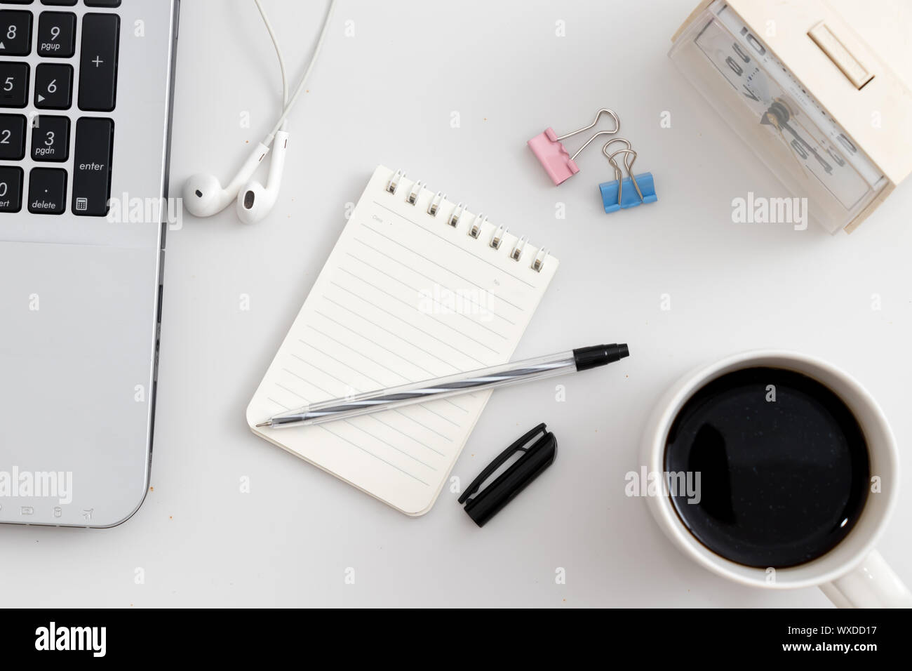 White office desk with notebook and pen Stock Photo - Alamy