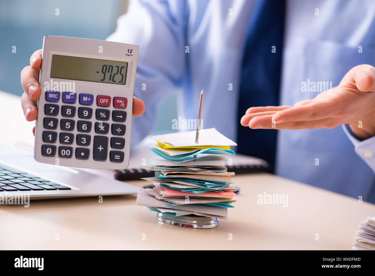Young male employee in budget planning concept Stock Photo - Alamy