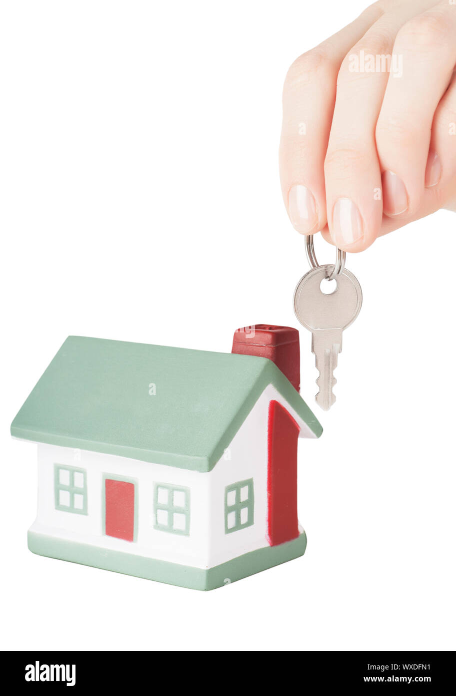 Little house toy and hand with key isolated over white background Stock
