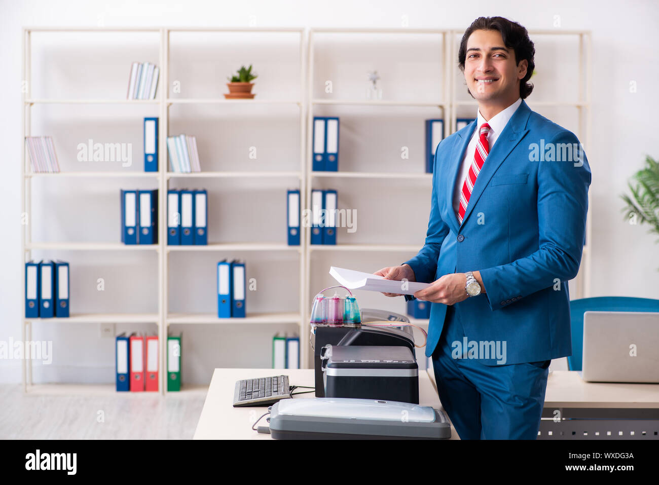 Working Copy Cop Young employee making copies at copying machine Stock Photo - Alamy