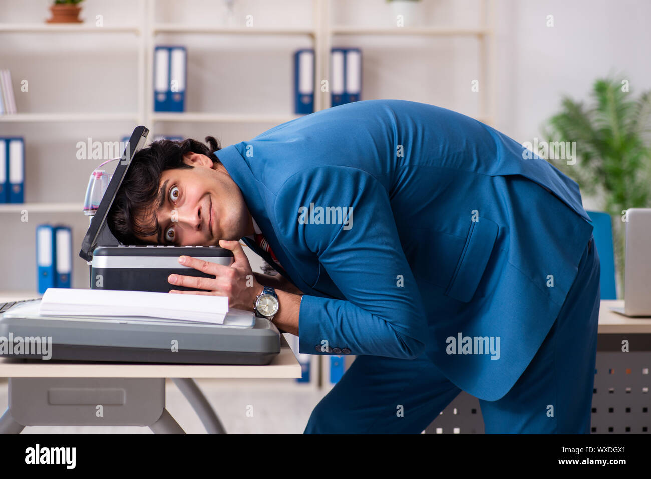 Working Copy Cop Young employee making copies at copying machine Stock Photo - Alamy