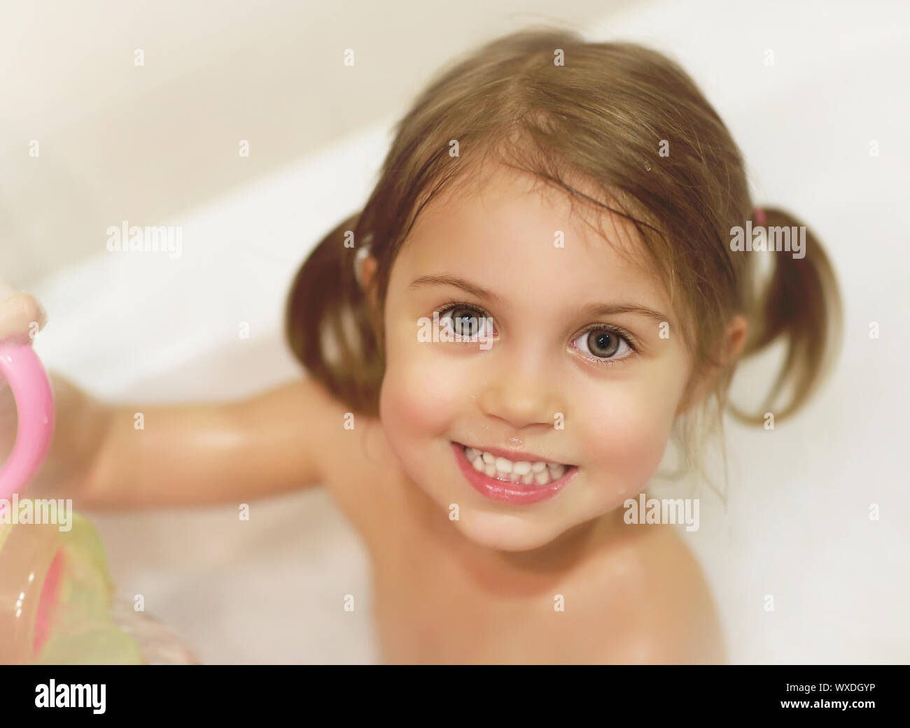 Photo of cute baby girl taking bath, happy childhood, child's hygiene