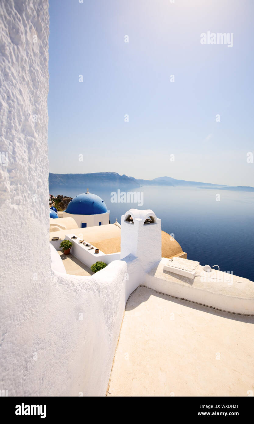 Blue domed church in Oia overlooks the spectacular caldera surrounding ...