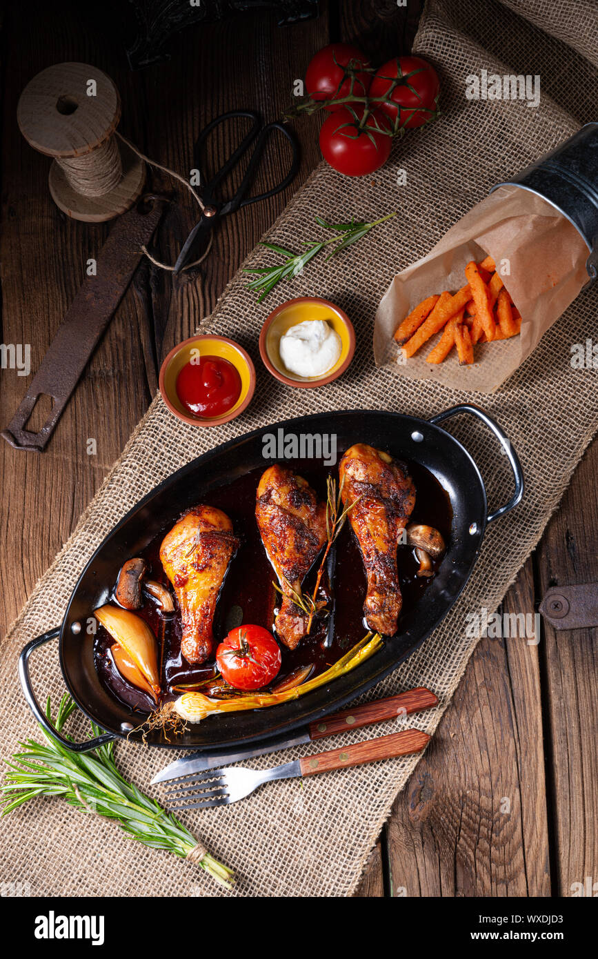 grilled chicken legs in barbecue marinade with sweet potatoes Stock