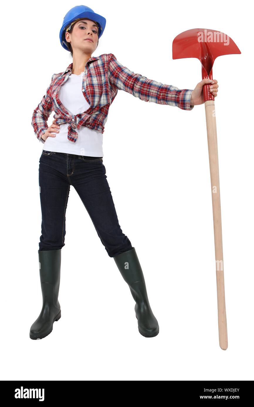 Woman proudly holding spade Stock Photo Alamy