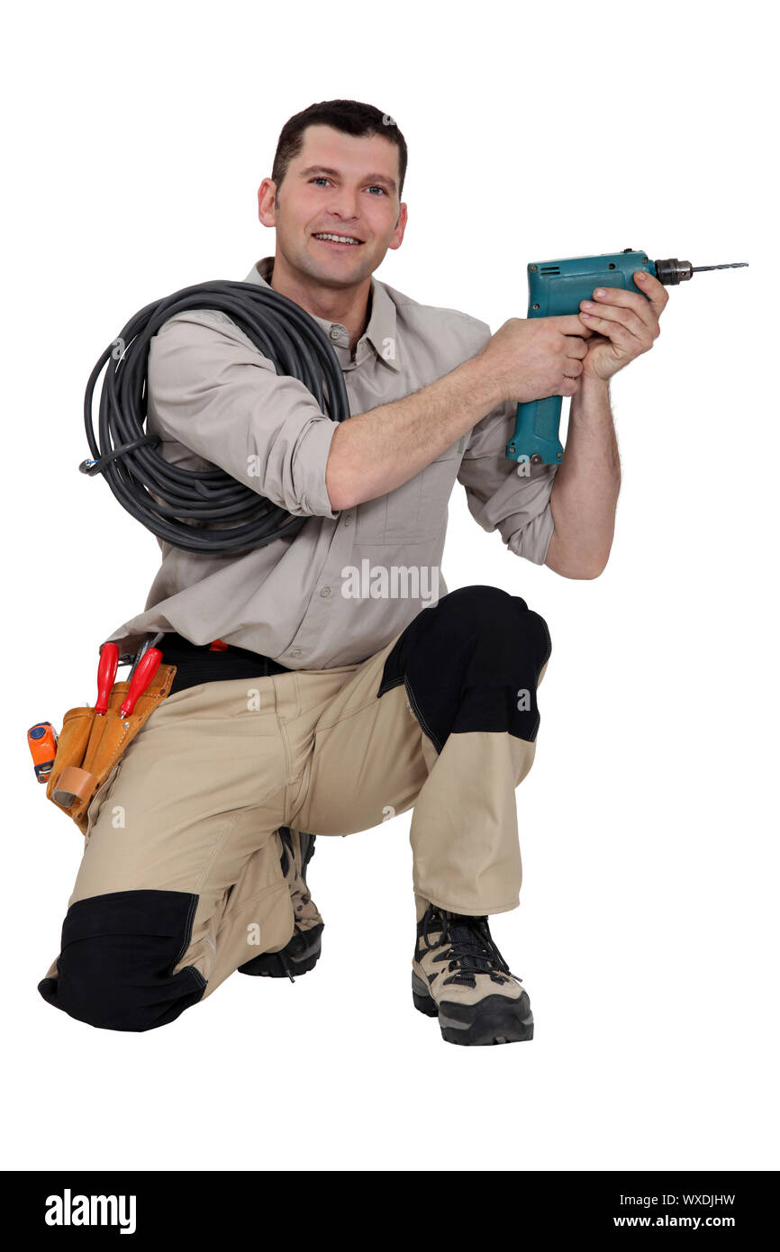Handyman holding a power tool Stock Photo Alamy