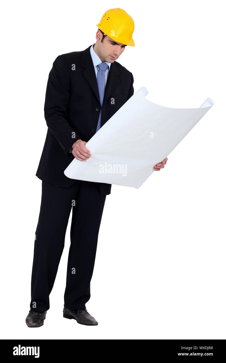Architect inspecting building plans Stock Photo - Alamy
