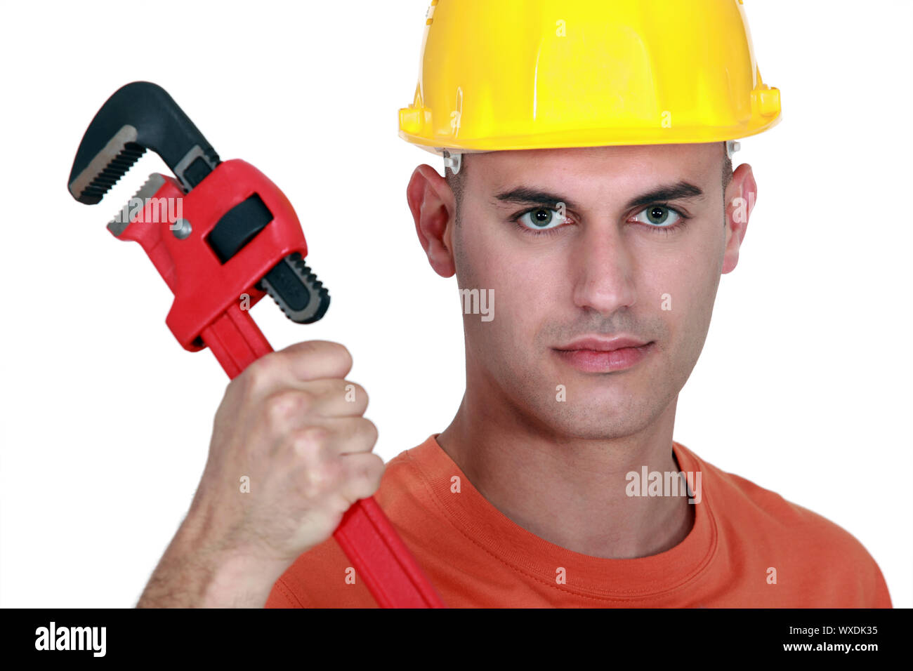 Tradesman holding a pipe wrench Stock Photo Alamy