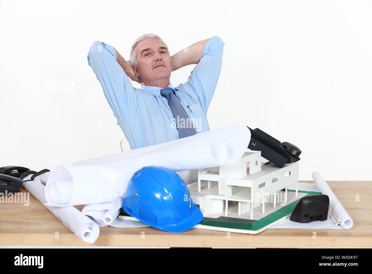 Architect sat at desk Stock Photo