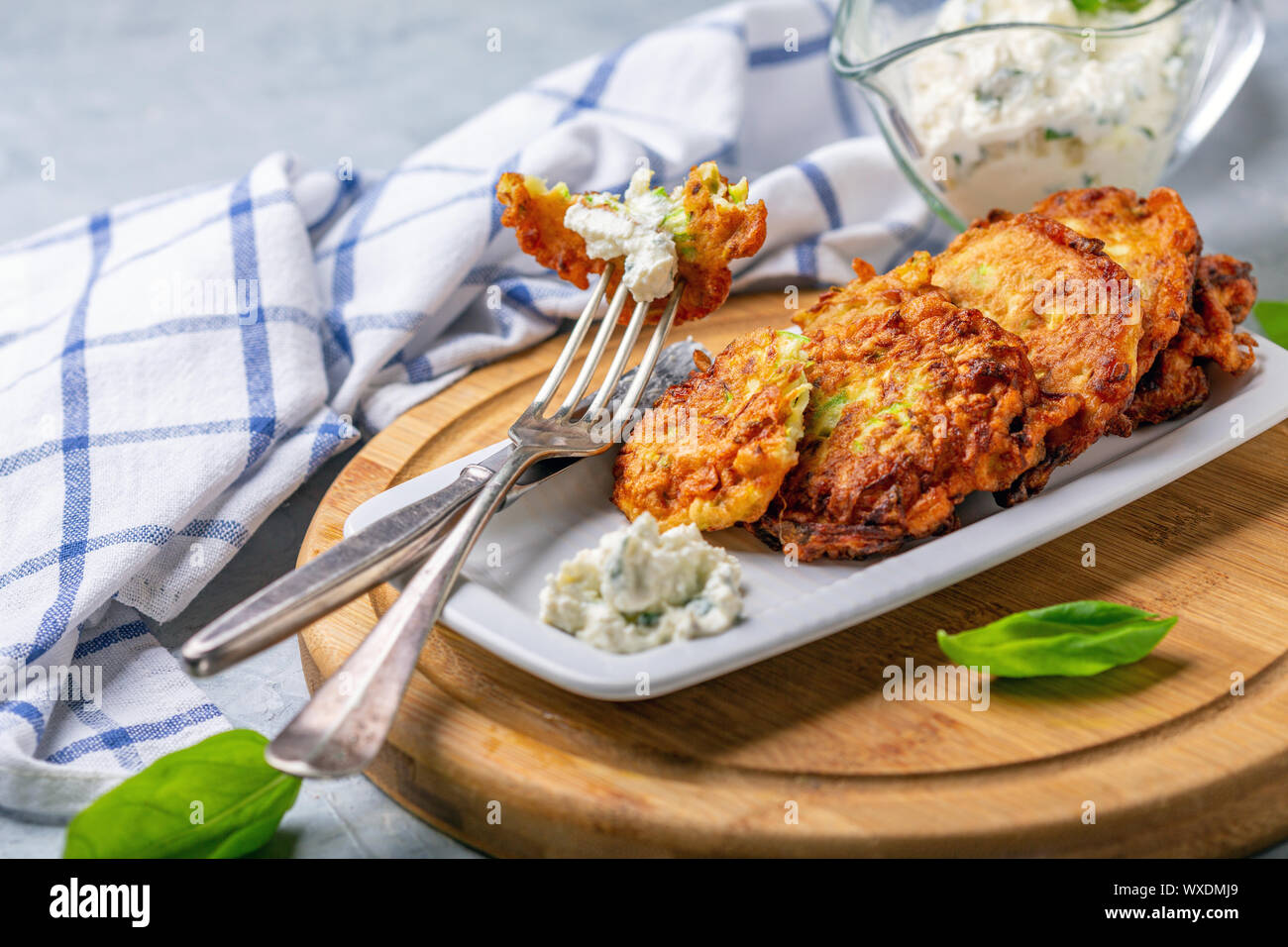 Zucchini fritters with cottage cheese sauce Stock Photo Alamy