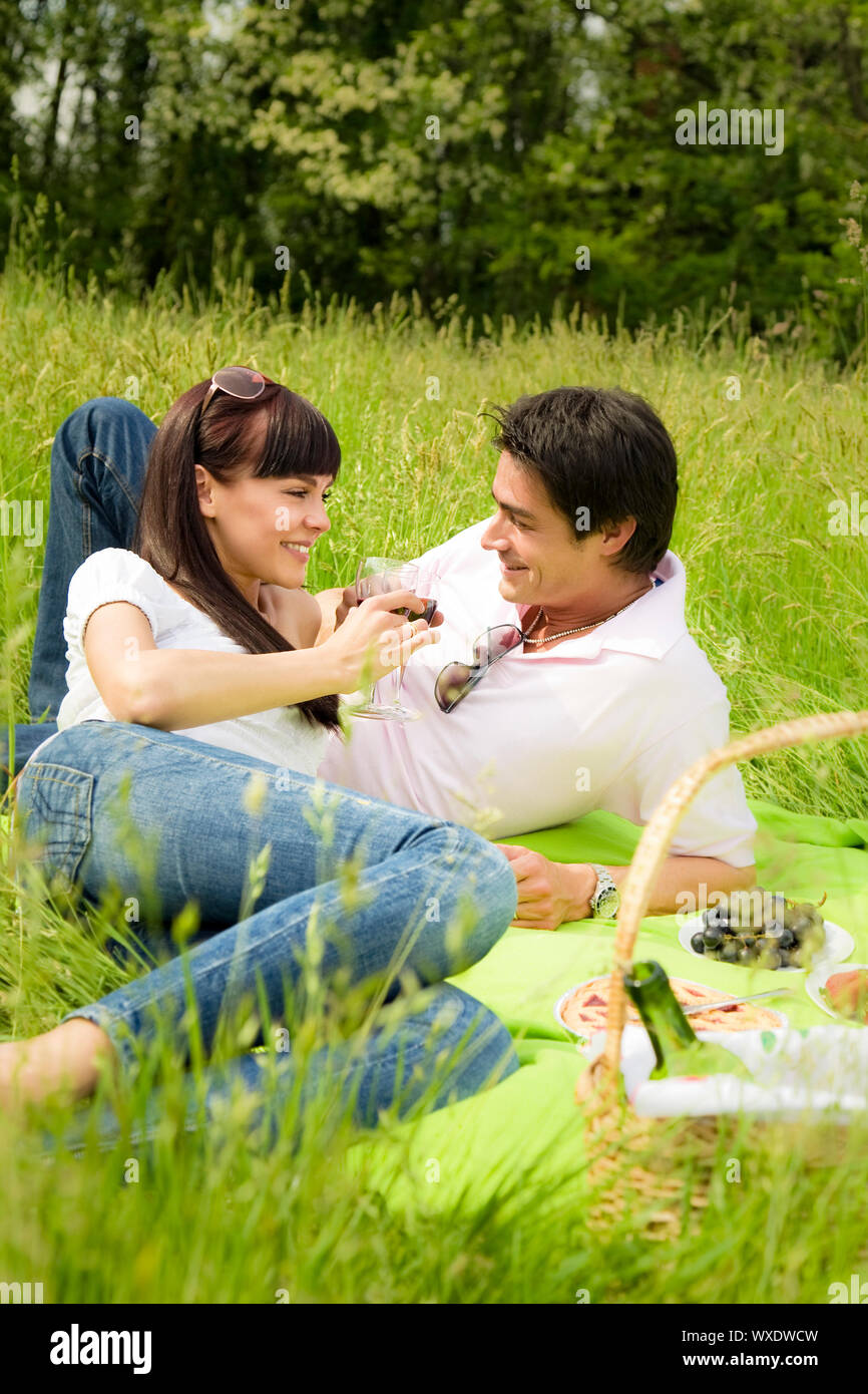couple having a picnic in a park, smiling Stock Photo - Alamy
