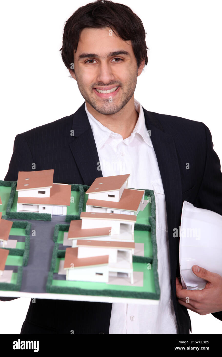 young architect holding a model of a building Stock Photo Alamy