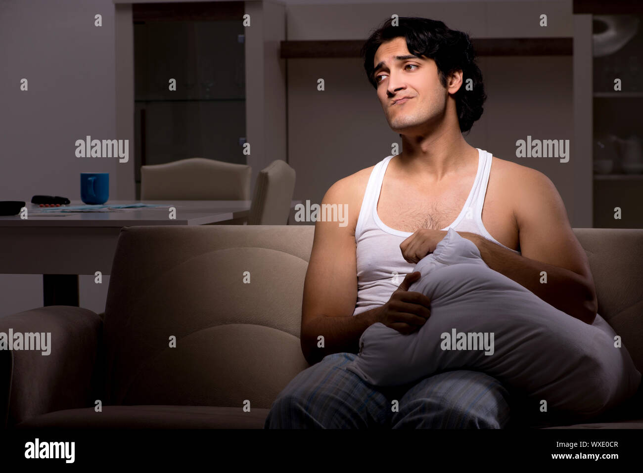 Young man suffering at home night time Stock Photo