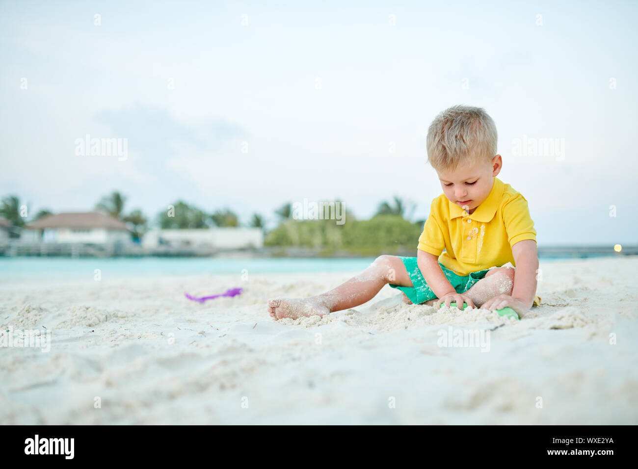 Three year old toddler playing on beach stock photo alamy