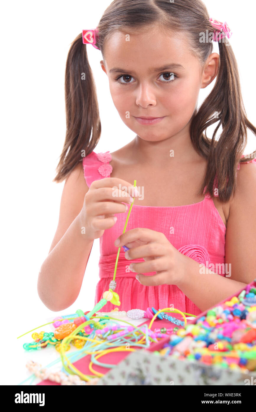 Little girl making necklace Stock Photo Alamy