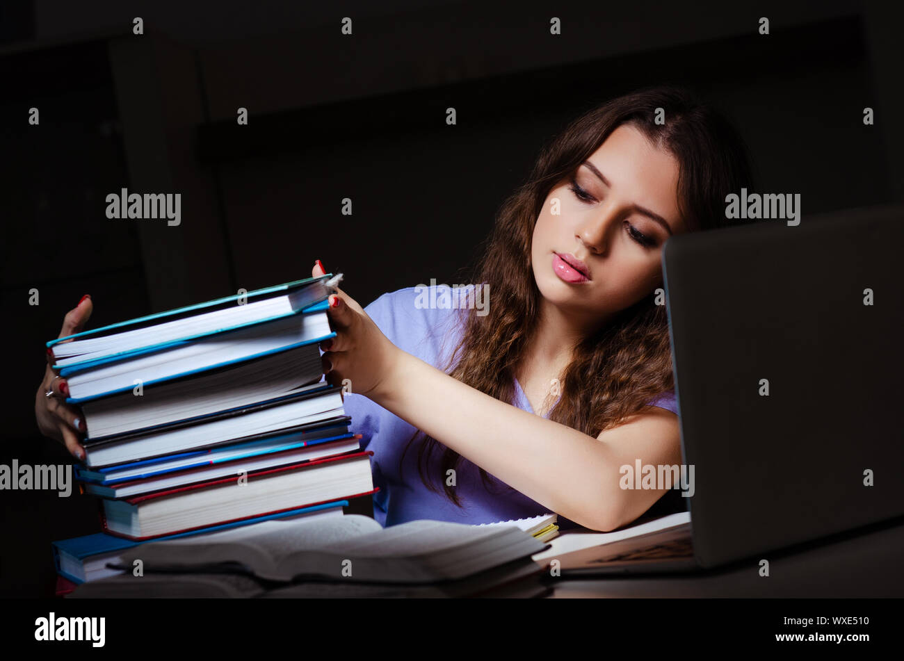 Young female student preparing for exams late at home Stock Photo - Alamy
